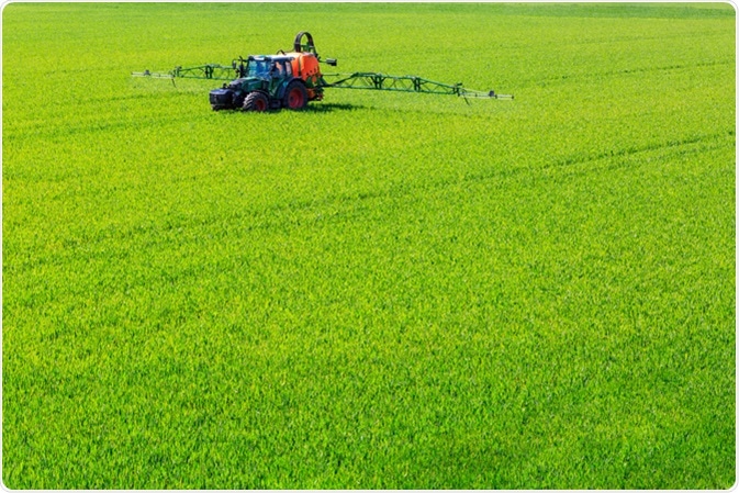 Tractor spraying glyphosate pesticides on a crop. Image Credit: GerDuess / Shutterstock