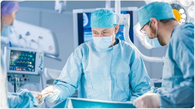 Surgeon carrying out brain surgery - By Gorodenkoff