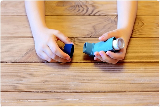 Child holding asthma inhaler in hands. Image Credit: OnlyZoia / Shutterstock
