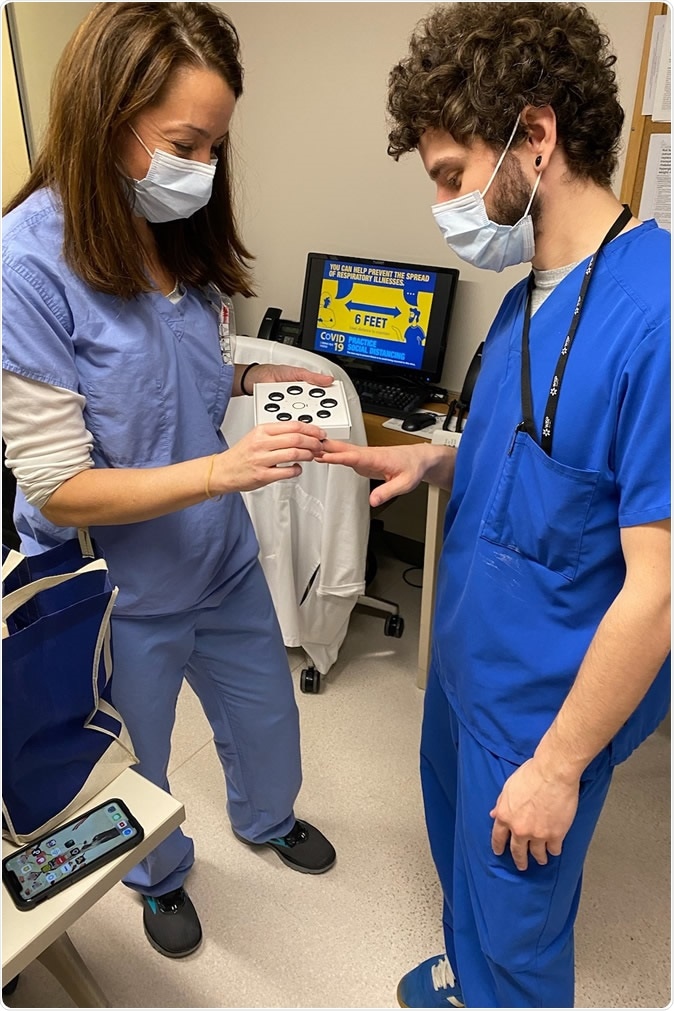 Leslie Crossley, registered nurse, sizes providers in the WVU Medicine J.W. Ruby Memorial Hospital Medical Intensive Care Unit for their Oura Rings.
