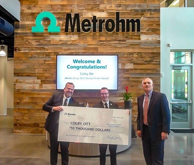 Dr. Colby Ott (center) receiving the Metrohm USA Young Chemist Award in 2022.