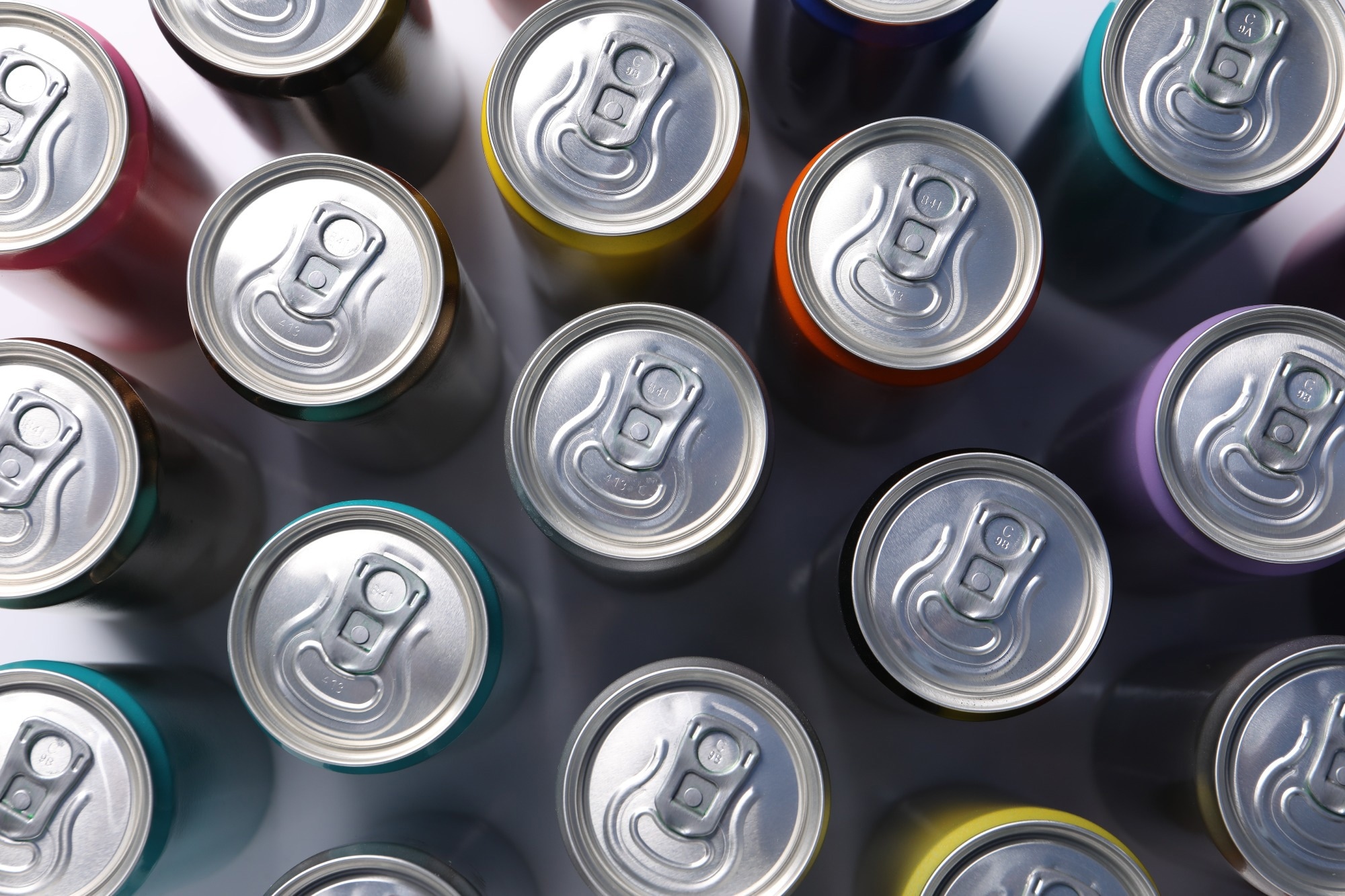 Many aluminium cans of beverage on table, flat lay