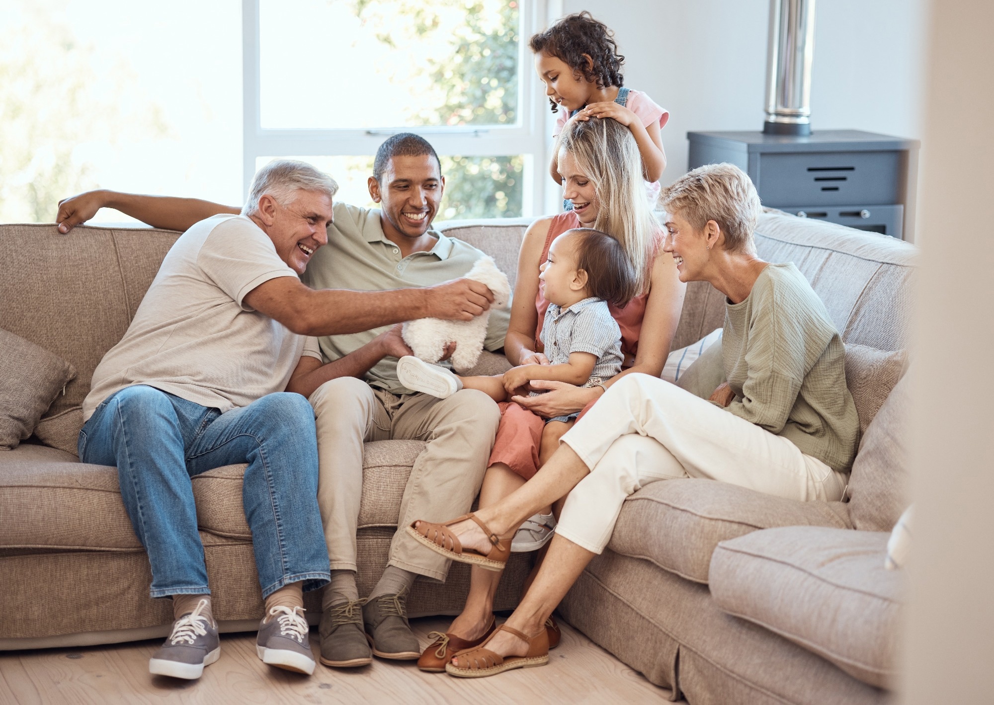 Happy, love and big family relaxing on sofa together in the living room of their house