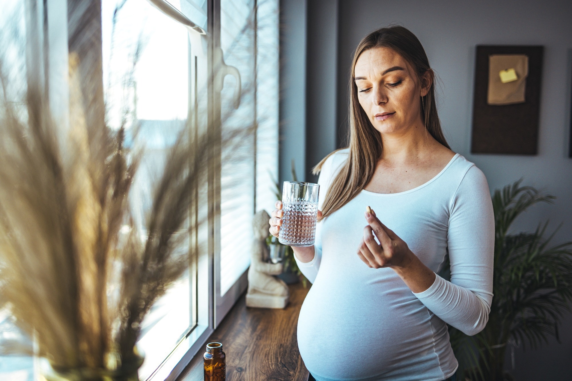 Picture of pregnant woman taking medication pills